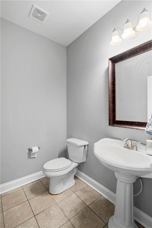 bathroom with tile patterned flooring and toilet