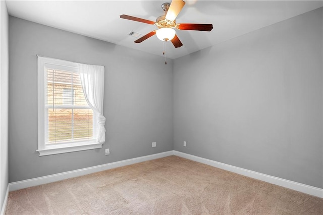 empty room with light colored carpet, plenty of natural light, and ceiling fan