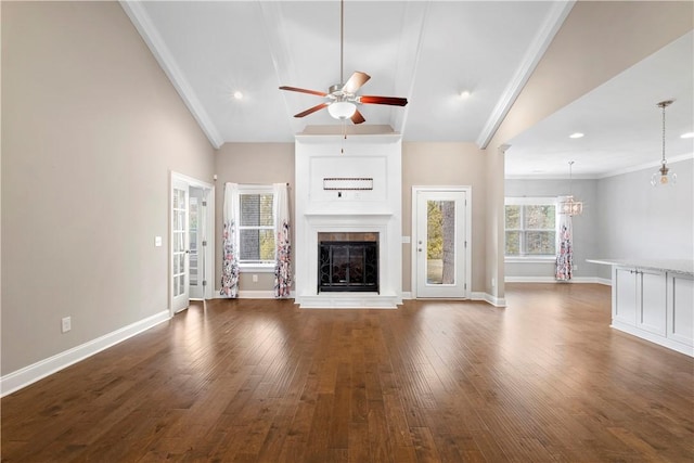 unfurnished living room featuring crown molding, ceiling fan with notable chandelier, dark hardwood / wood-style floors, and high vaulted ceiling