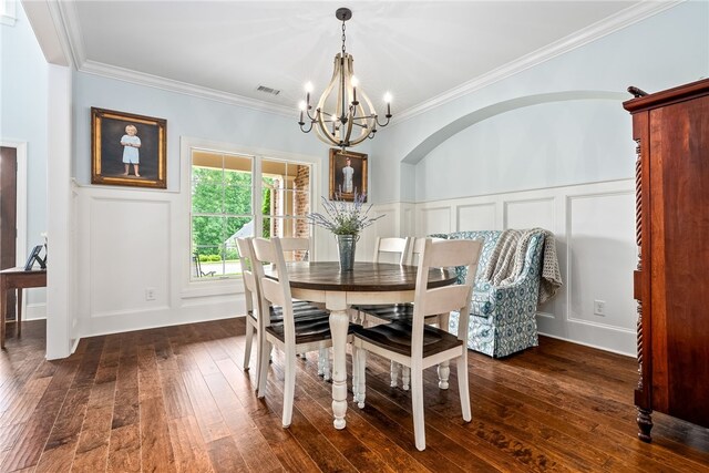 523 Merimont Blvd, Auburn, AL 36830 - dining room with a chandelier, a decorative wall, dark wood-style flooring, crown molding, and a wainscoted wall