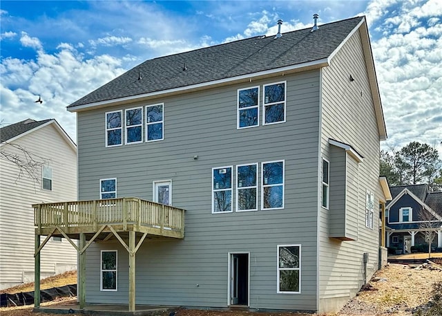 rear view of house with a wooden deck