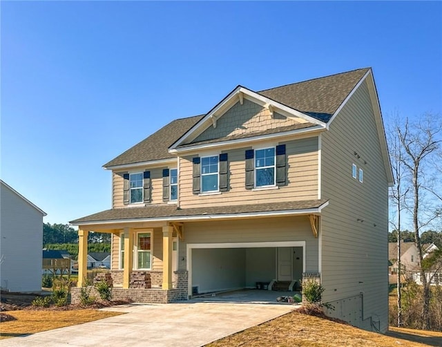 craftsman-style house with covered porch, an attached garage, and concrete driveway