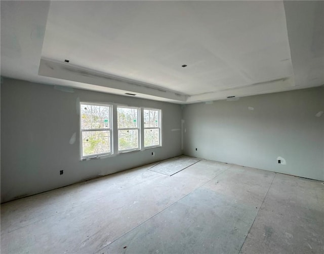 spare room featuring a raised ceiling