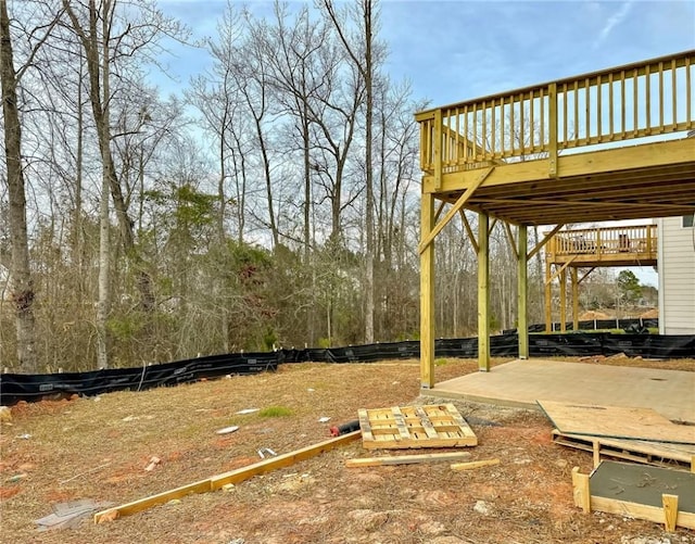 view of yard featuring a deck and a patio