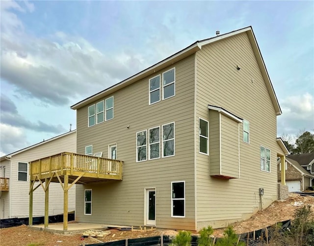 back of property featuring a patio and a deck