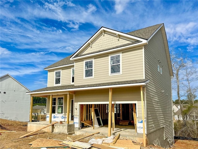 back of property with a porch