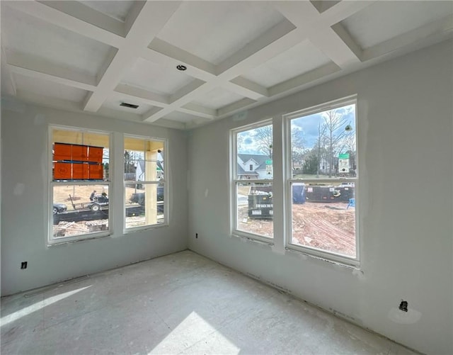 spare room with plenty of natural light, beamed ceiling, coffered ceiling, and visible vents