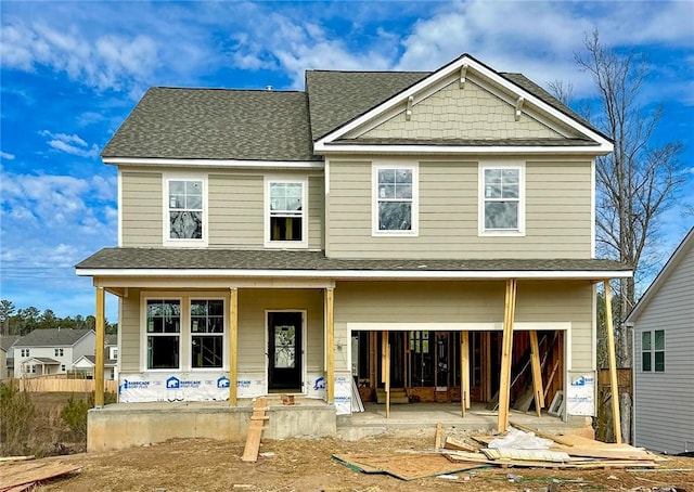 view of front facade featuring a porch and a garage