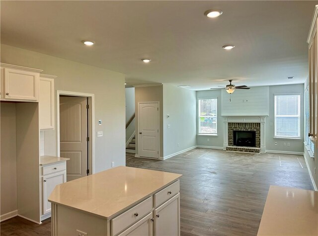 2248 Red Tail Ln, Auburn, AL 36879 - kitchen featuring ceiling fan, white cabinetry, a kitchen island, light countertops, and baseboards