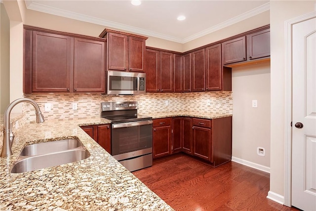 1931 Sequoia Dr, Auburn, AL 36879 - kitchen featuring appliances with stainless steel finishes, dark wood-style flooring, light stone counters, backsplash, and ornamental molding