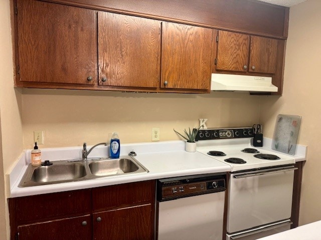 kitchen with white appliances, light countertops, a sink, and under cabinet range hood