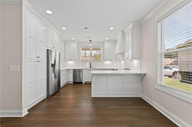 2140 Autumn Ridge Way, Auburn, AL 36879 - kitchen with appliances with stainless steel finishes, a peninsula, dark wood-style flooring, backsplash, and recessed lighting
