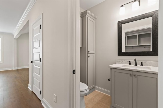 2140 Autumn Ridge Way, Auburn, AL 36879 - bathroom with vanity, wood finished floors, baseboards, toilet, and ornamental molding