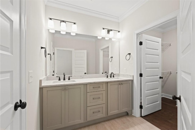 2140 Autumn Ridge Way, Auburn, AL 36879 - bathroom featuring double vanity, wood finished floors, a walk in closet, and crown molding