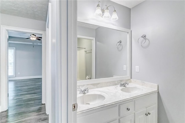 2331 Morgan Dr, Auburn, AL 36830 - bathroom featuring double vanity, wood finished floors, and a ceiling fan