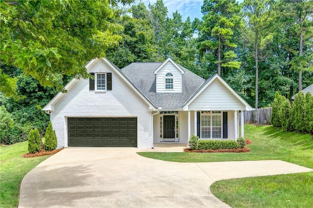 2331 Morgan Dr, Auburn, AL 36830 - traditional-style house featuring driveway, an attached garage, roof with shingles, brick siding, and a porch