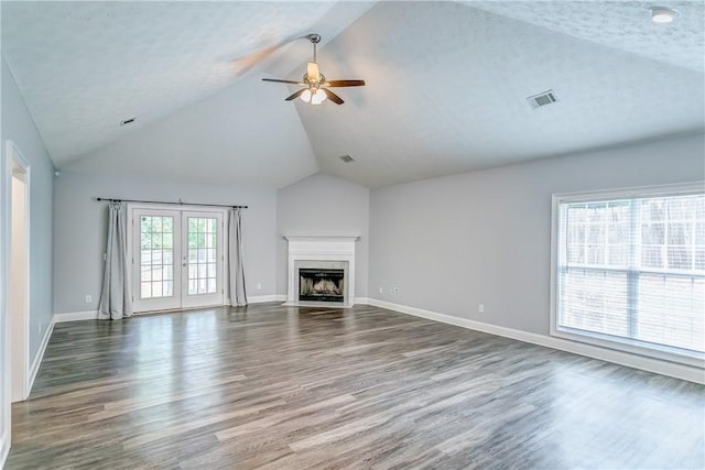 2331 Morgan Dr, Auburn, AL 36830 - unfurnished living room with a ceiling fan, wood finished floors, a fireplace with flush hearth, french doors, and high vaulted ceiling