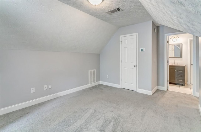 2331 Morgan Dr, Auburn, AL 36830 - additional living space featuring a textured ceiling, carpet flooring, and lofted ceiling