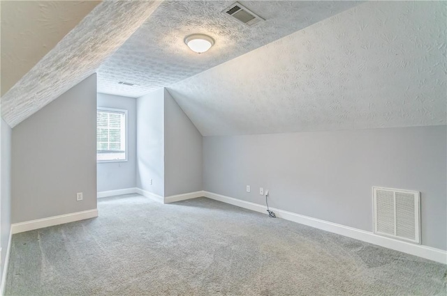 2331 Morgan Dr, Auburn, AL 36830 - bonus room featuring a textured ceiling, carpet flooring, and lofted ceiling