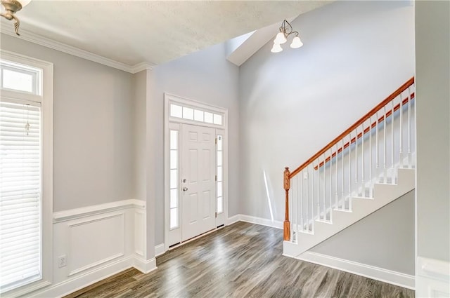 2331 Morgan Dr, Auburn, AL 36830 - foyer entrance with healthy amount of natural light, wood finished floors, stairway, crown molding, and a chandelier