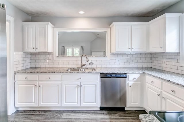 2331 Morgan Dr, Auburn, AL 36830 - kitchen with stainless steel dishwasher, white cabinets, dark wood finished floors, recessed lighting, and backsplash