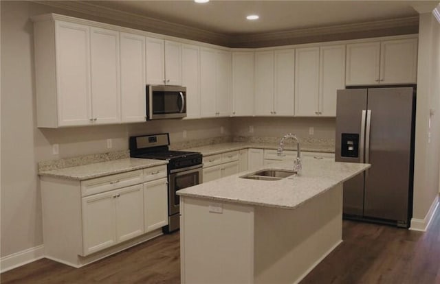 kitchen with stainless steel appliances, sink, a center island with sink, and white cabinets