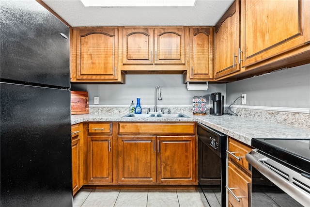 427 Harper Ave Unit 16, Auburn, AL 36830 - kitchen with black appliances, brown cabinets, and light tile patterned floors
