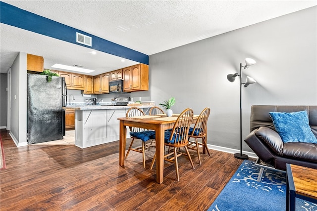 427 Harper Ave Unit 16, Auburn, AL 36830 - dining space with wood finished floors and a textured ceiling