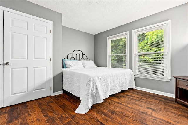 427 Harper Ave Unit 16, Auburn, AL 36830 - bedroom featuring wood finished floors and a textured ceiling