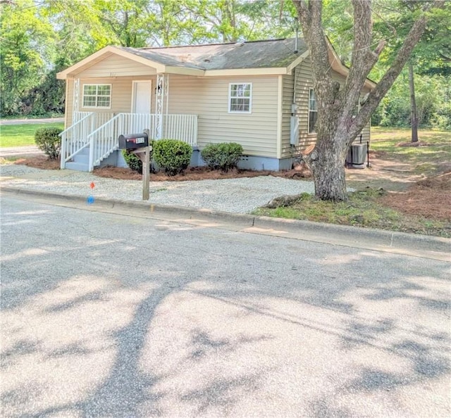 view of front of house with central AC unit and crawl space