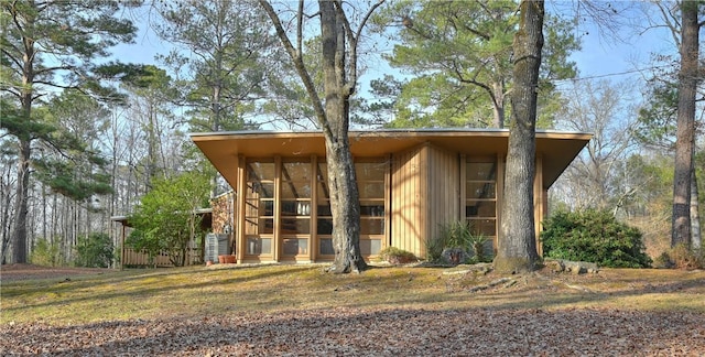 view of outdoor structure featuring a sunroom