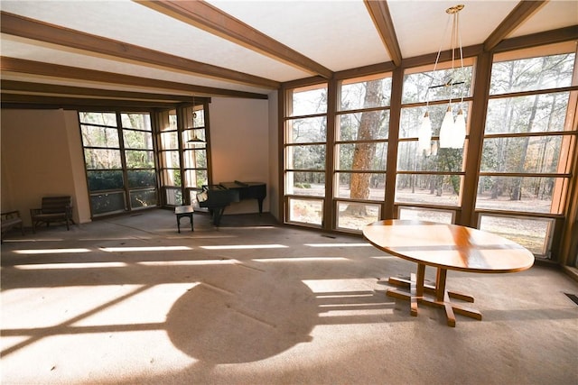 unfurnished sunroom featuring beamed ceiling