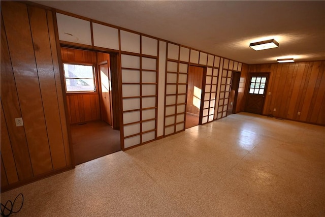 spare room with wood walls