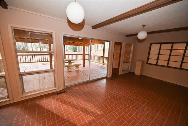 empty room with beamed ceiling