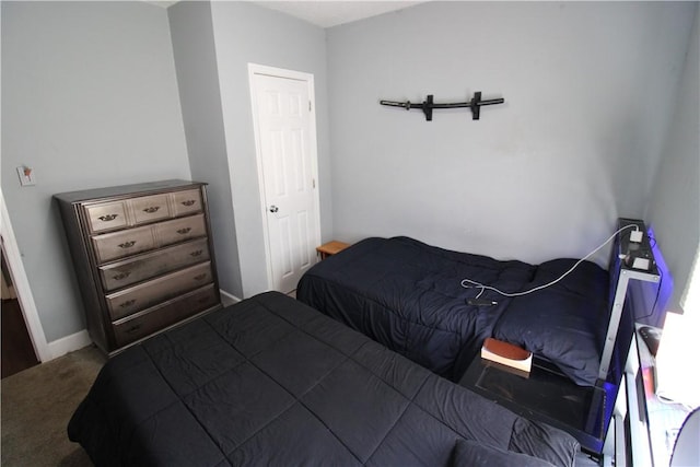 bedroom with baseboards and carpet floors