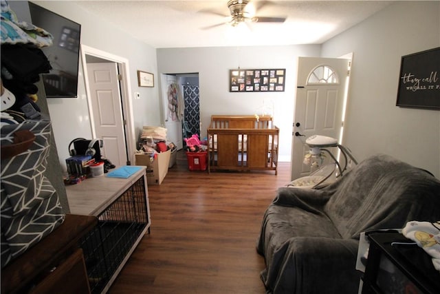 living room with ceiling fan and wood finished floors