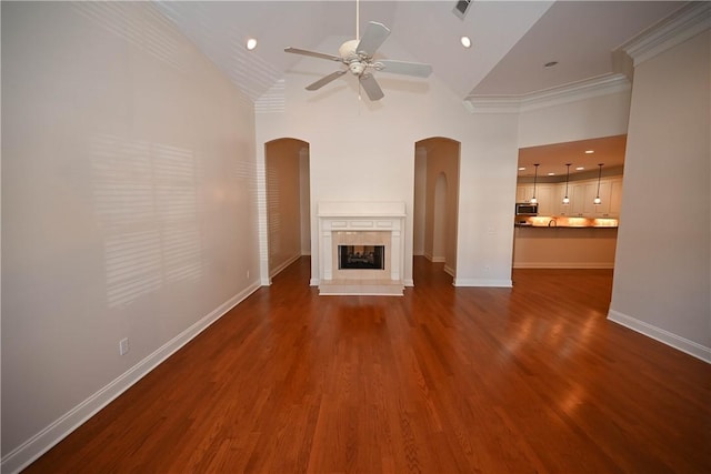 1758 Brookeview Ct, Auburn, AL 36830 - unfurnished living room with arched walkways, a ceiling fan, baseboards, dark wood-style floors, and crown molding