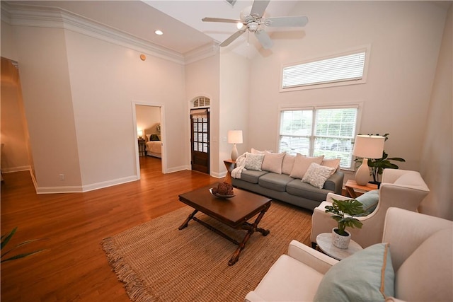 1758 Brookeview Ct, Auburn, AL 36830 - living room featuring a high ceiling, ornamental molding, baseboards, wood finished floors, and a ceiling fan