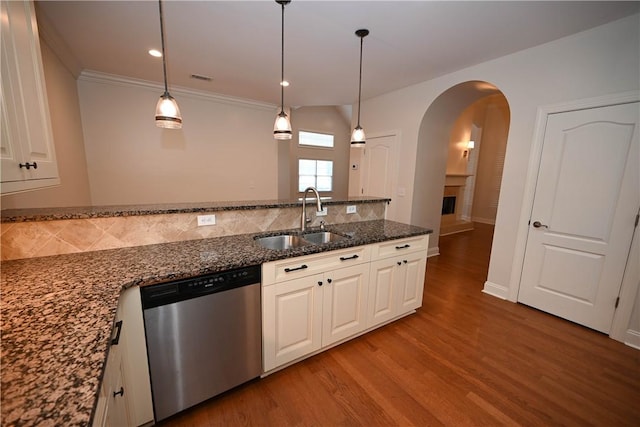 1758 Brookeview Ct, Auburn, AL 36830 - kitchen featuring dishwasher, a sink, backsplash, light wood-style flooring, and arched walkways