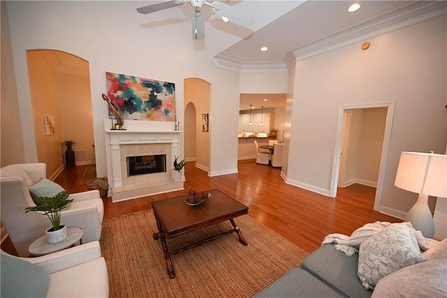 1758 Brookeview Ct, Auburn, AL 36830 - living area featuring arched walkways, a ceiling fan, wood finished floors, a high ceiling, and ornamental molding