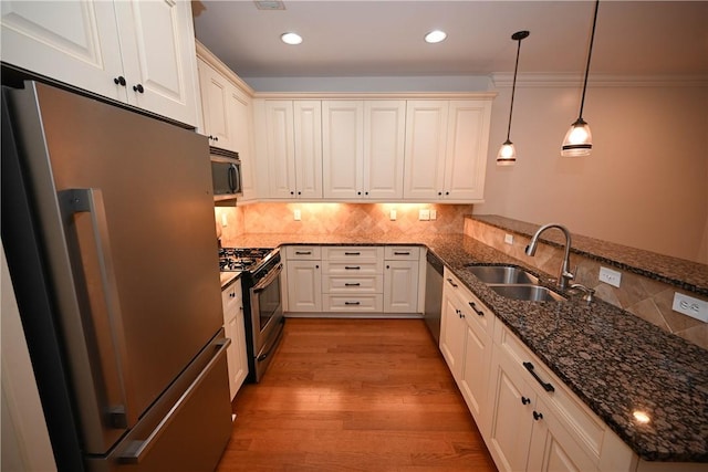 1758 Brookeview Ct, Auburn, AL 36830 - kitchen with appliances with stainless steel finishes, a sink, a peninsula, backsplash, and decorative light fixtures