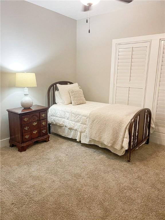 carpeted bedroom with ceiling fan