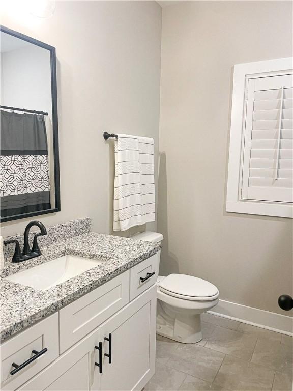 bathroom featuring vanity and toilet