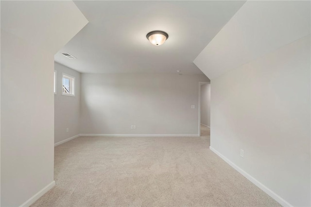 bonus room featuring light carpet