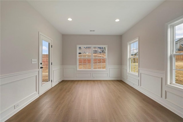 unfurnished dining area featuring wood-type flooring