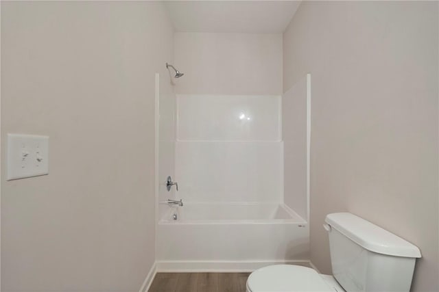 bathroom featuring hardwood / wood-style floors,  shower combination, and toilet