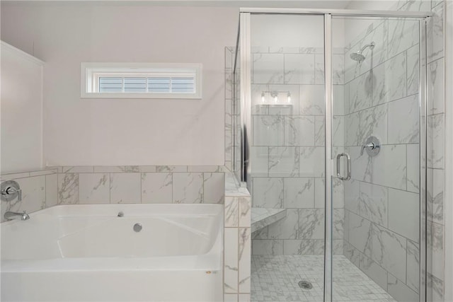 bathroom with separate shower and tub