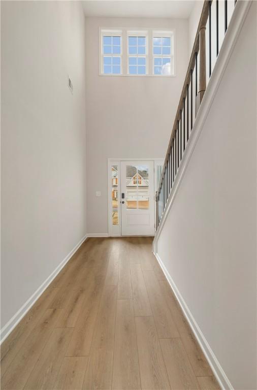 entrance foyer featuring light hardwood / wood-style floors and a high ceiling