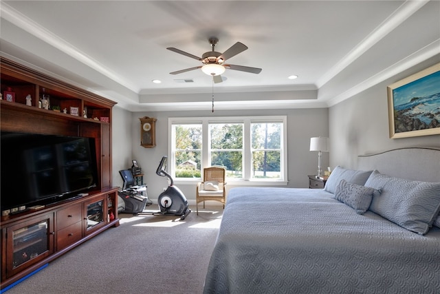 bedroom featuring carpet, ceiling fan, crown molding, and a tray ceiling