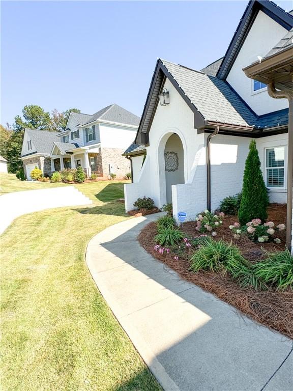 exterior space with a garage and a front lawn